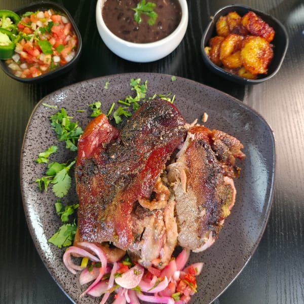 Crispy roasted pork with sweet plantains, black beans, pico de gallo, and pickled red onions.